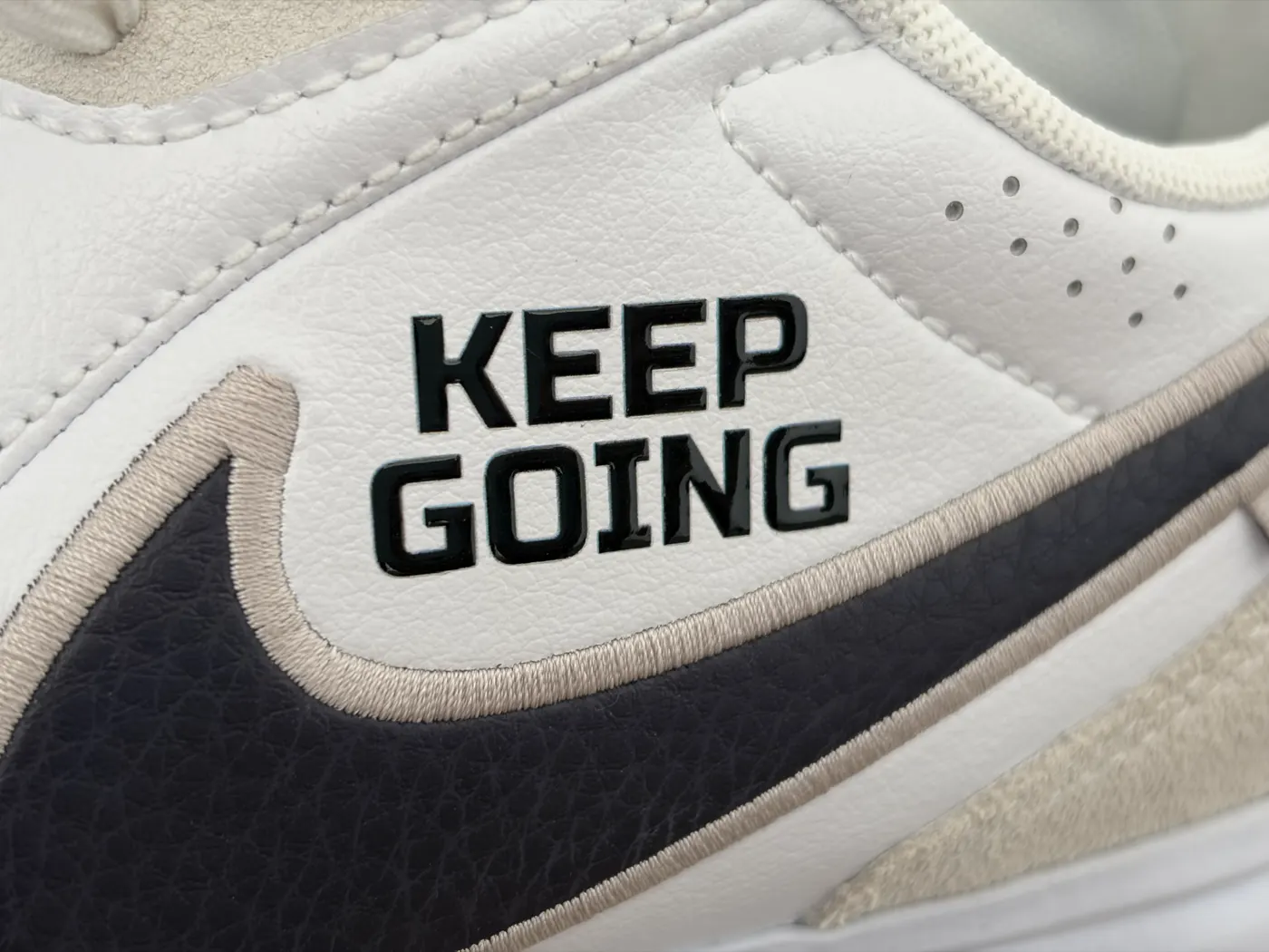 Keep Going word transfer on the side of a white boot