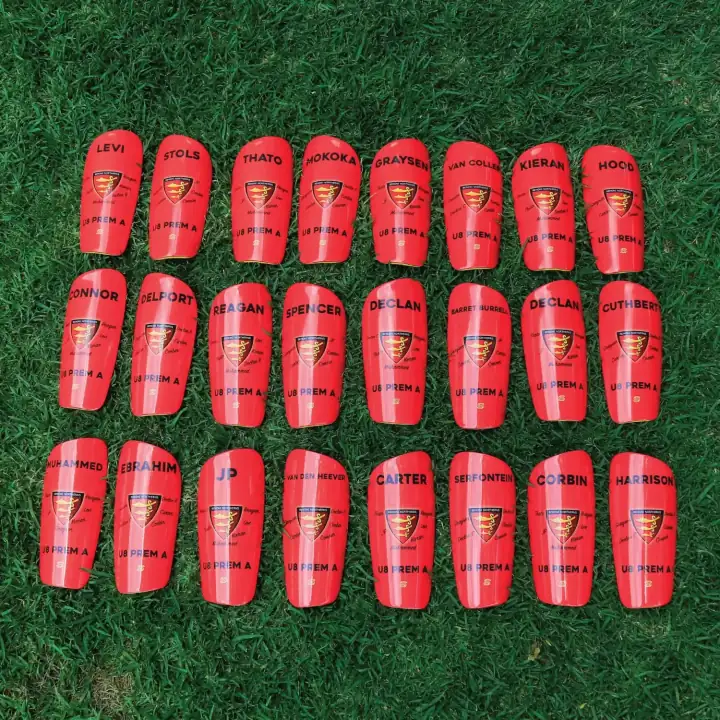 24 red Benoni Northerns U8 shin pads, each with a player name and the club crest
