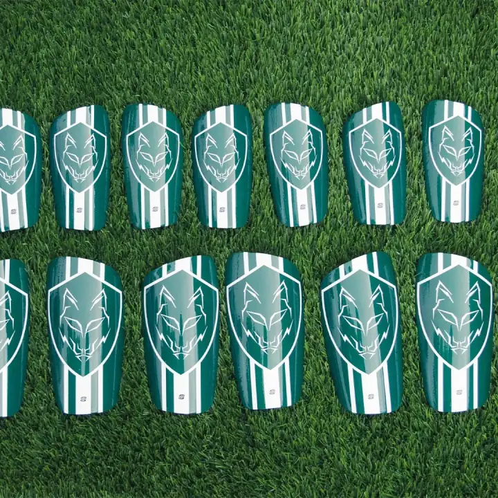 A squad set of green and white striped shin pads with a wolf crest