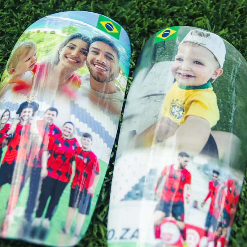 Custom photo shin pads with family pictures and a Brazil flag