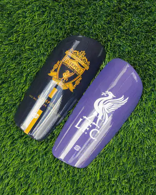 Liverpool shin pads: gold crest and purple Liver bird