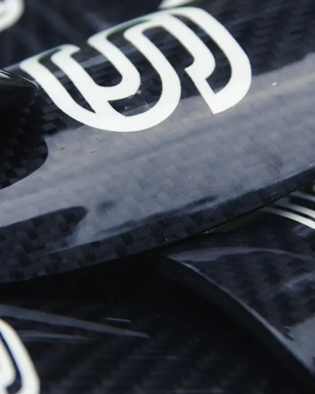 Edge of a carbon fibre shin pad showing the weave