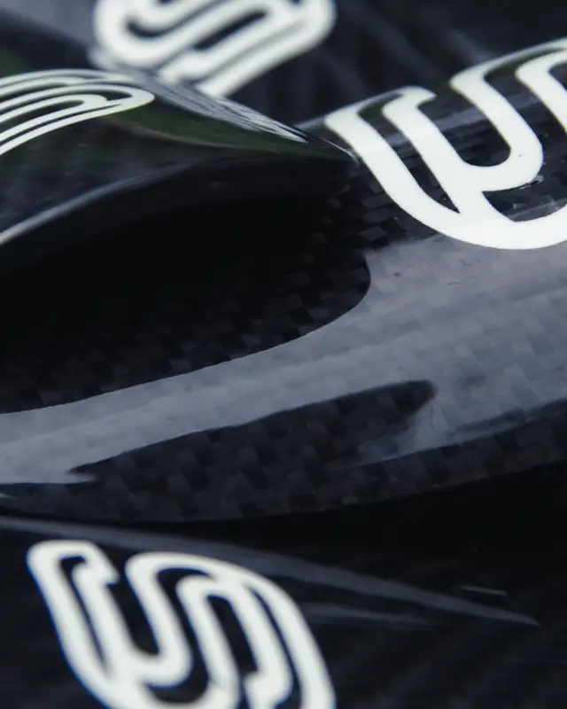 Stacked carbon fibre shin pads with white S logos