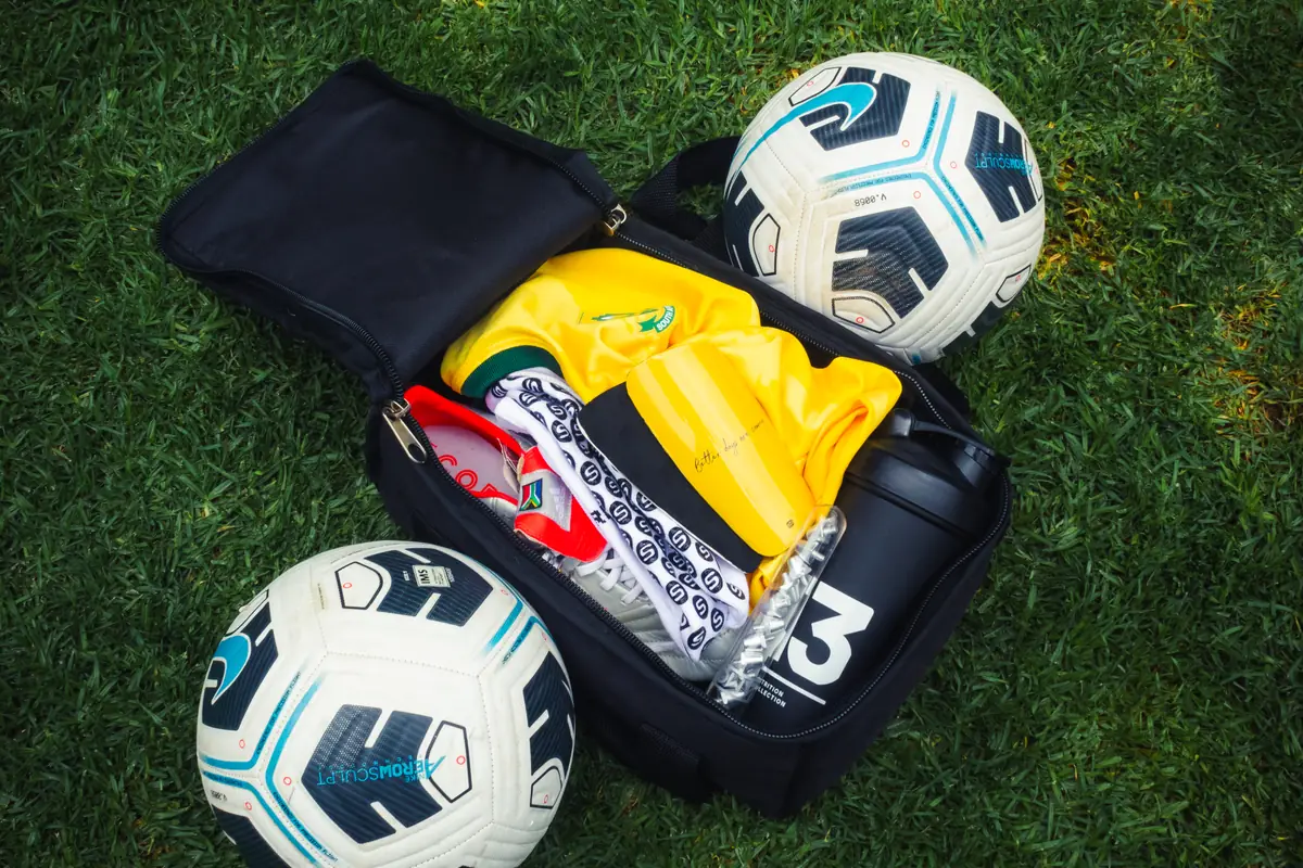 Open kit bag with custom shin pads, grip socks and boots