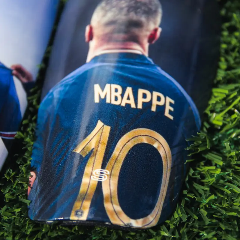 Custom shin pads with a player's name and number 10 on the back of a shirt