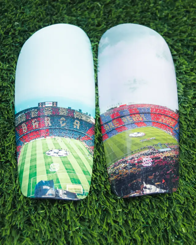 Pair of custom shin pads printed with a packed stadium